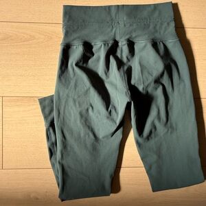 More of a dark teal color like the 3 pictures. Barely worn VUORI leggings